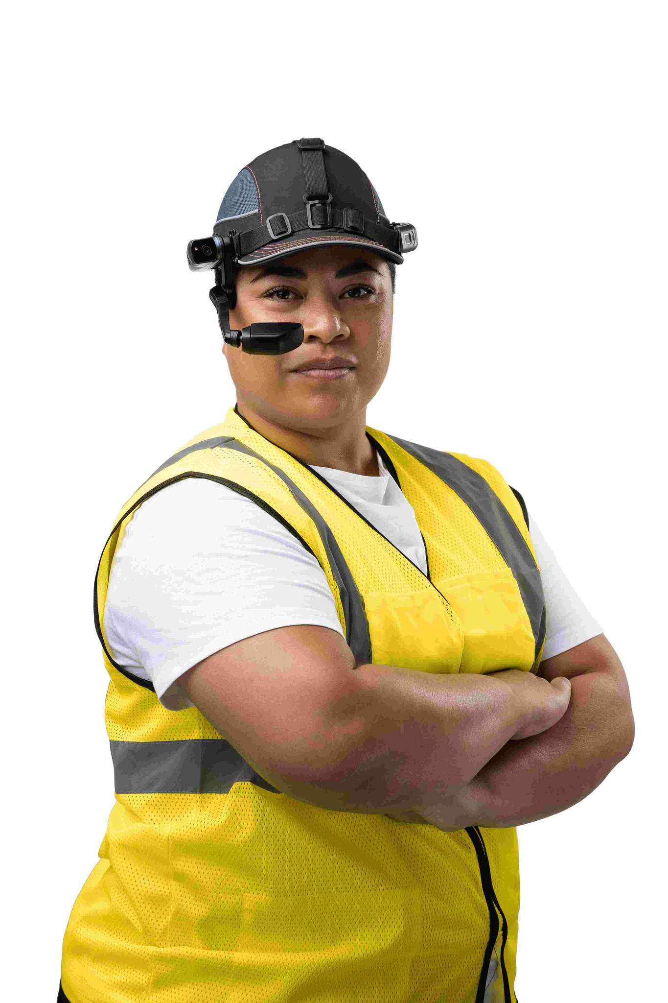 Person wearing a yellow reflective vest, white shirt, and RealWear Navigator™ 500 Rugged Handsfree Tablet with noise-canceling headset, standing with arms crossed against a white background.