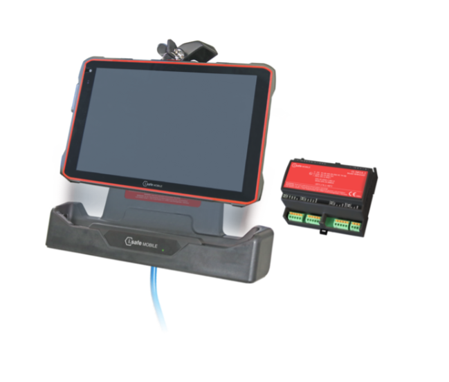 A rugged i.safe MOBILE IS-MOP1A.1 Mobile Operator Panel paired with the intrinsically safe IS940.1 (C1/D1) Android tablet is shown in its charging dock, featuring a blue cable and positioned next to a compact black and red control device with connector ports—ideal for use alongside ex-rated peripherals in challenging explosive atmospheres.