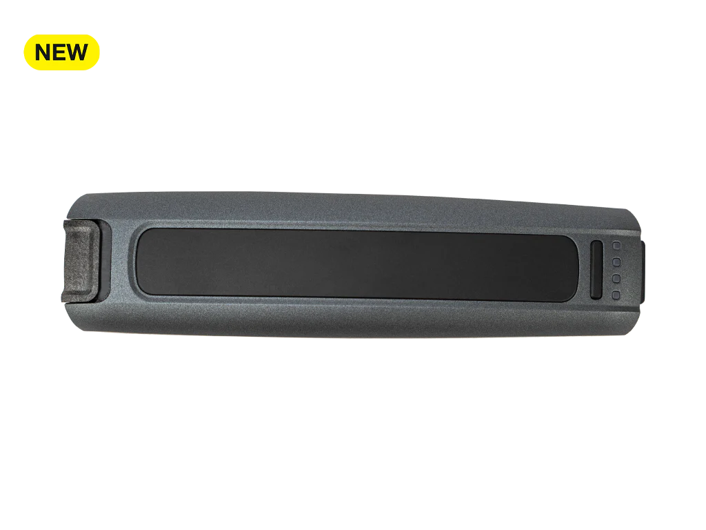 The RealWear Battery Pack Nav 500 Series is a rectangular, dark gray device with black accents and three buttons on one end, marked "NEW" in a yellow box.
