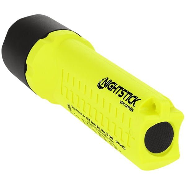 A yellow Nightstick XPP-5418GX Intrinsically Safe Flashlight with a black rubberized end and textured grip rests on its side, highlighting its ATEX certified construction.