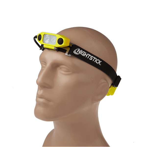 A mannequin head wears the Nightstick XPP-5462GX DICATA™ Intrinsically Safe Low-Profile Dual-Light™ Headlamp—black and yellow, with an adjustable strap, featuring front-facing LED lights and Dual-Light™ spotlight/floodlight technology.