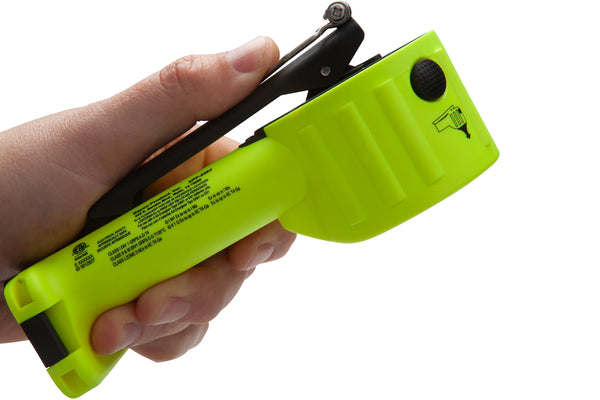 A hand holds the Nightstick XPP-5564GXA INTRANT® DUO IS Dual-Light Angle Light—bright green with black details, featuring a seatbelt cutter, button, and integrated LED flashlight—against a white background.