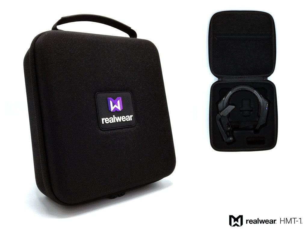A RealWear HMT-1 headset is displayed inside an open RealWear Semi Rigid Carrying Case for the HMT-1 and HMT-1Z1 Wearable Tablets, with a closed case beside it. Both carry the RealWear logo.