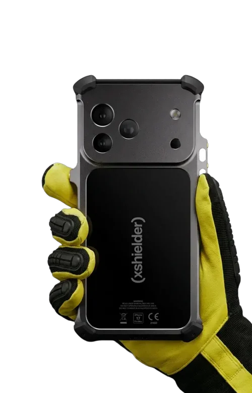 A gloved hand holds the Xshielder ATEX & IECEx Zone 1/21 Cover for iPhone 17 Pro Max (phone included), featuring reinforced corners, a thick shell, and multiple camera lenses—perfect for ultimate device protection in hazardous zones.