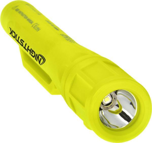 The Nightstick XPP-5410G [Zone 0] IS Permissible Penlight is a yellow LED flashlight with a cylindrical body and a reflective interior around the LED bulb.