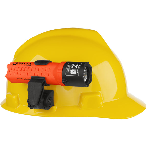 A yellow hard hat with a Nightstick XPP-5418RX-K01 [Zone 0] IS Flashlight (3 AA) in orange/black, NFPA-1971-8.6 compliant, securely attached to the front with a black mounting clip.