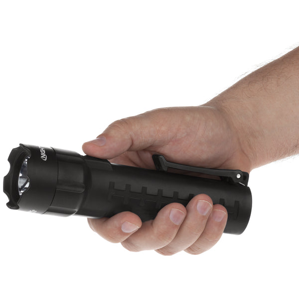 A hand holds the Nightstick XPP-5420B [UL-913] IS Permissible Flashlight—a black LED flashlight with a textured grip and side clip—against a plain white background. Its IP-67 rating ensures durability in tough conditions.