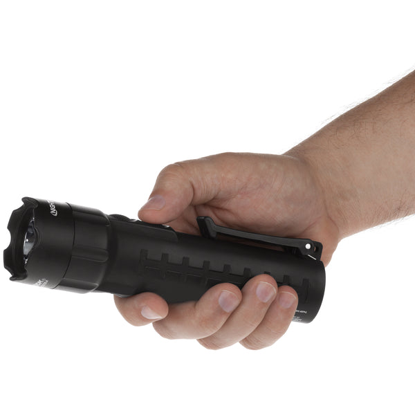 A hand holds the Nightstick XPP-5422B [UL-913] IS Permissible Dual-Light Flashlight horizontally against a white background.