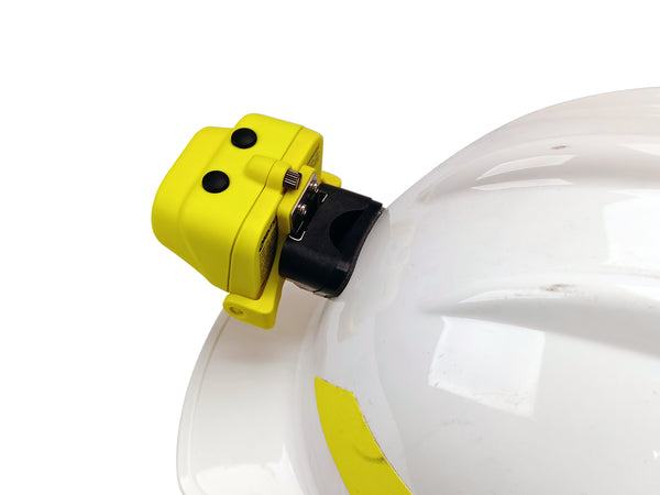 A close-up of a white hard hat with the Nightstick XPP-5454GC [Zone 0] IS Dual-Light Headlamp w/kit, attached to the front via a hard hat clip. The background is plain white.