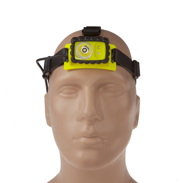 A mannequin head wears a Nightstick XPP-5456G [Zone 0] IS Permissible Dual-Light Headlamp with an adjustable strap on the forehead. This waterproof industrial headlamp has a central round light and two smaller side lights for versatile lighting.