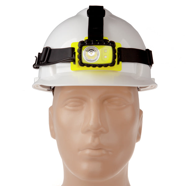 A white hard hat with a Nightstick XPP-5458G [Zone 0] IS Permissible Dual-Light Headlamp, featuring a yellow and black design, is shown mounted on a mannequin head.