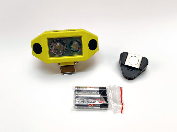The Nightstick XPP-5460GCX [Zone 0] IS Low-Profile Dual-Light Headlamp (yellow) is shown with a clip, magnetic and hard hat mounts, plus three AAA batteries in a plastic bag, all displayed on a white background.